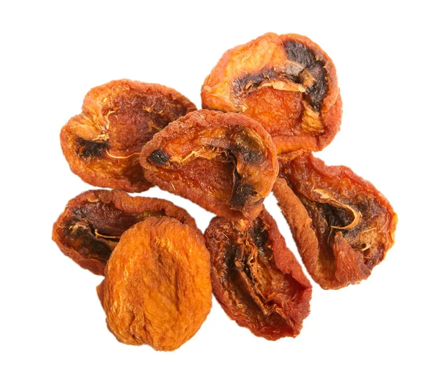 Small pile of Organic California Sun Dried Apricot Halves with varied colors ranging from dark brown to deep orange.