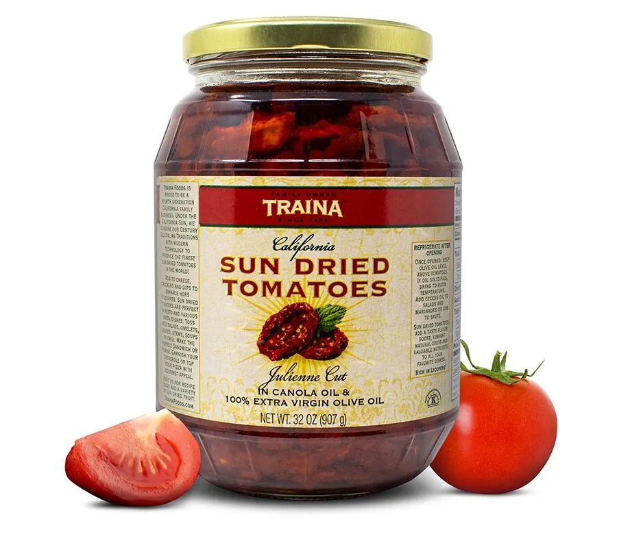 Close-up of Traina® Home Grown California Sun Dried Tomatoes in Oil, Julienne Cut, in a glass jar with twist cap. Gourmet, ready-to-use tomatoes packed in seasoned oil, perfect for enhancing pizzas, pastas, sandwiches, and more at large events.