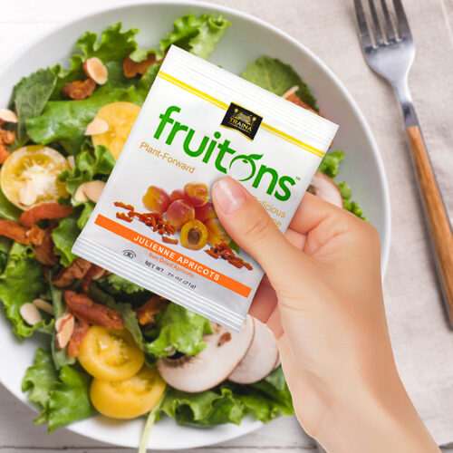 A vibrant salad topped with Fruitons® Sun Dried Apricot strips, adding a burst of color, chewy texture, sweet flavor, and a boost of fiber.
