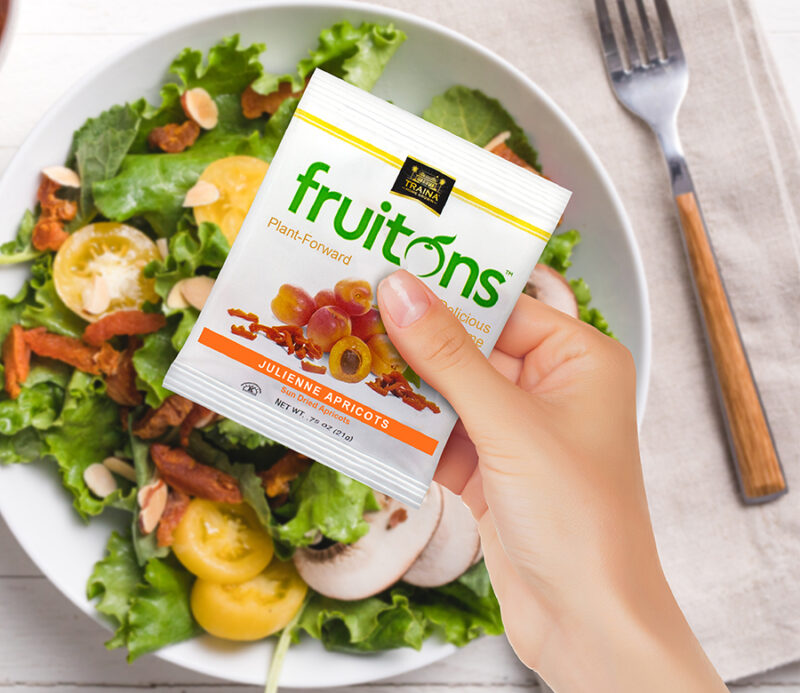 A vibrant salad topped with Fruitons® Sun Dried Apricot strips, adding a burst of color, chewy texture, sweet flavor, and a boost of fiber.
