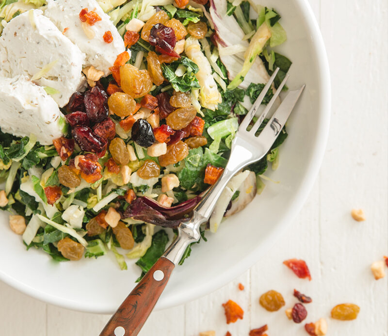 fruitons® All American Dried Fruit Blend, the perfect topping for salads, adding color, texture, fiber, flavor, and nutrients, shown in a salad bowl.
