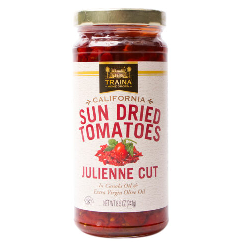 Close-up of Traina® Home Grown California Sun Dried Tomatoes in Oil, Julienne Cut, showcasing our vibrant red tomatoes in a glass jar with twist cap. Dried under the California sun. We pack in oil seasoned with our special spice blend for a rich savory flavor. A perfect ingredient to enhance the flavor of pizza, pasta, sandwiches, and so much more.
