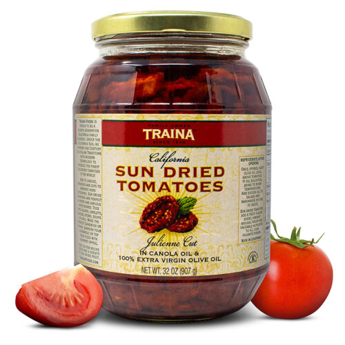 Close-up of Traina® Home Grown California Sun Dried Tomatoes in Oil, Julienne Cut, in a glass jar with twist cap. Gourmet, ready-to-use tomatoes packed in seasoned oil, perfect for enhancing pizzas, pastas, sandwiches, and more at large events.